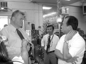 Mayor Greg Nickels, left, meets with Viet Wah grocery store owner Duc Tran, right. -- International Examiner Photo, August 8 & September 2, 2008